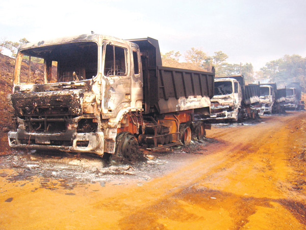 Burnt out trucks after NPA mine raid