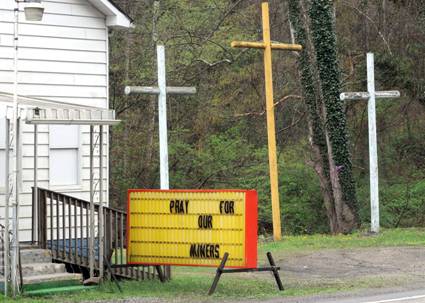 Crosses and sign act as memorial to dead US coal miners
