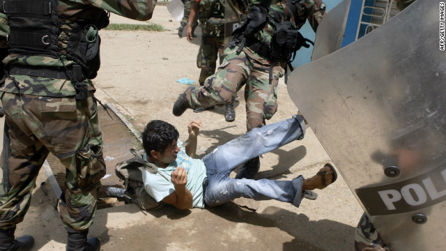 A gold miner clashes with Peruvian riot policemen during protests in the country's Madre de Dios region