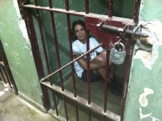 Eugenia Testa of Greenpeace sits in a police jail