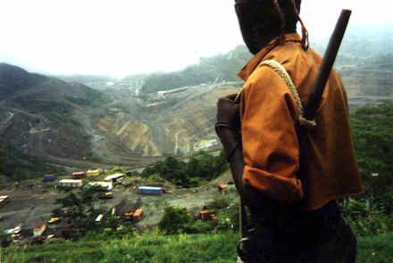 Young freedom fighter from the Bougainville Revolutionary Army <br>stands guard over the Panguna copper mine