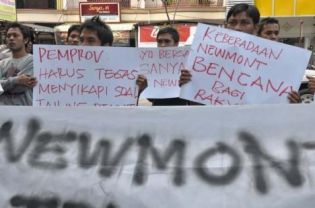 Protestors hold a demonstration outside the offices of Newmont Nusa Tenggara